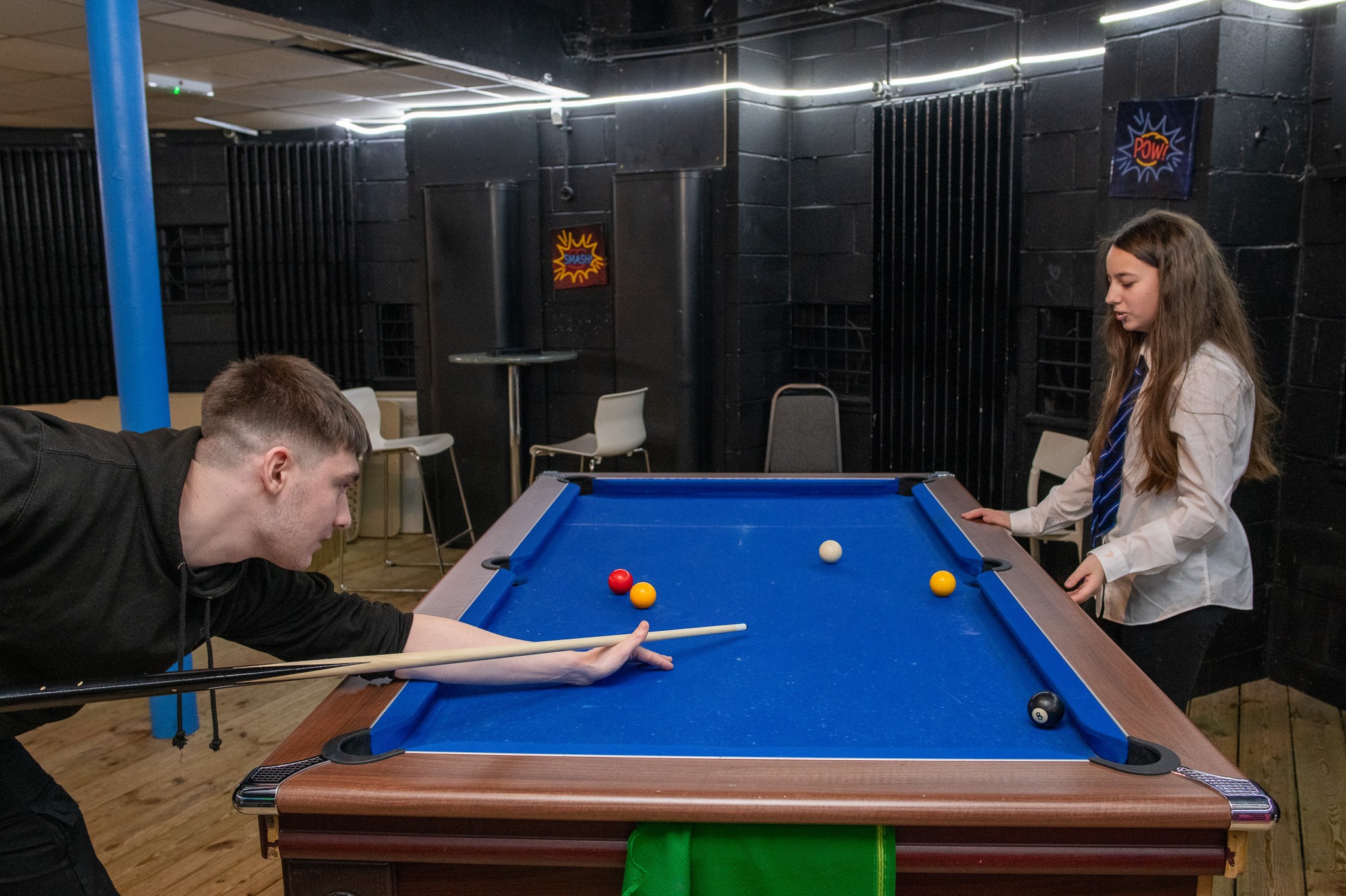 2 children playing a game of pool